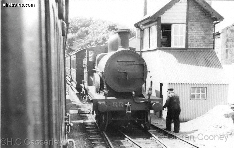 Crusheen_20110117_001_CC_JA.jpg - A D17 Class 4-4-0 stands at Crusheen Station with a northbound train from Limerick in the 1930s. On the right is the signal cabin and goods shed. ©H.C Casserley